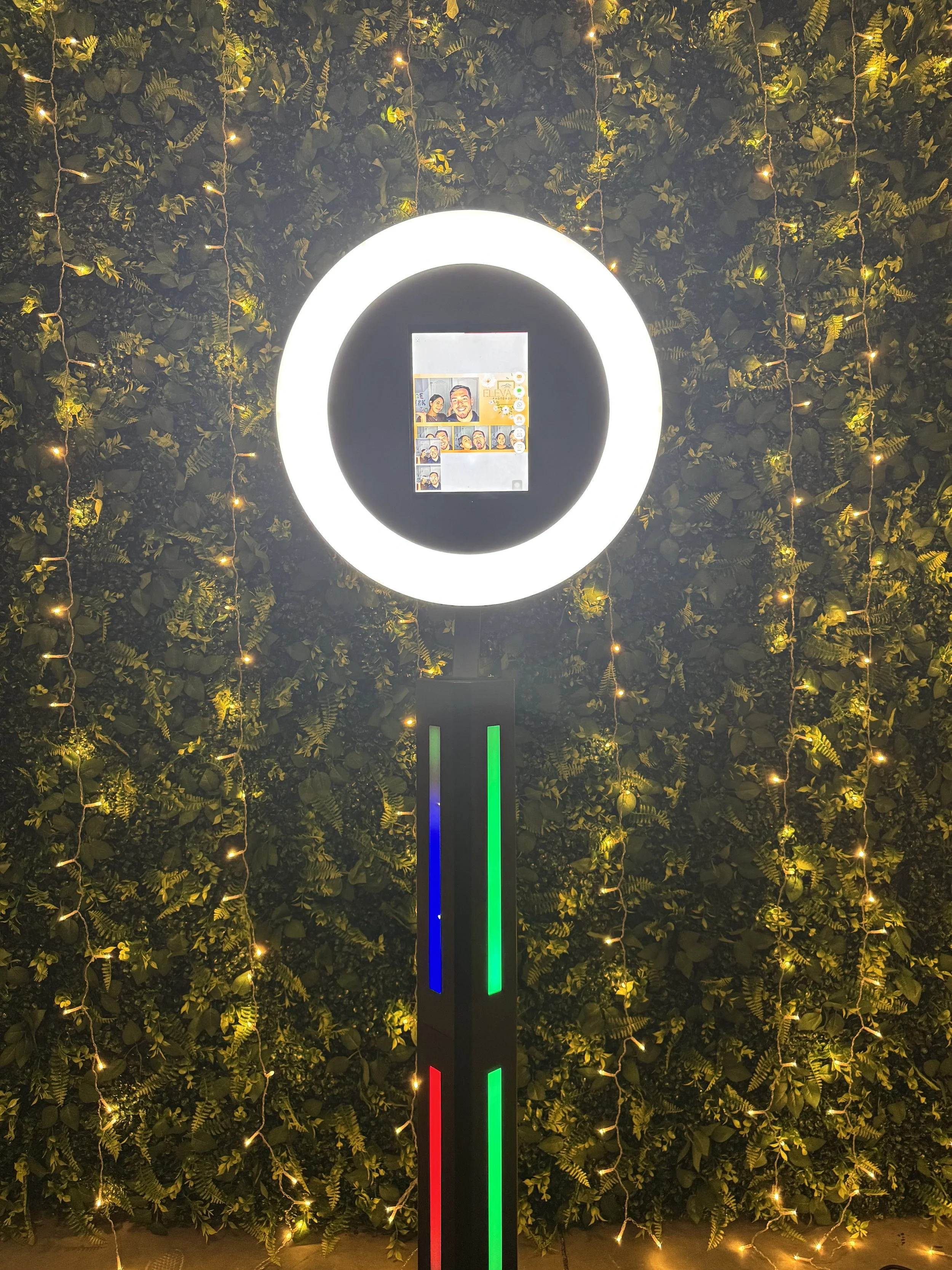 Black drop-off photo booth in front of a sequin backdrop